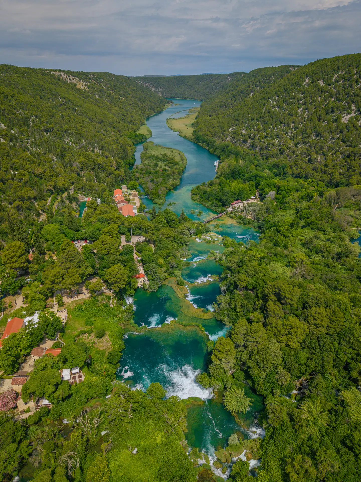 aerial view of a waterfalls and lakes in the woods