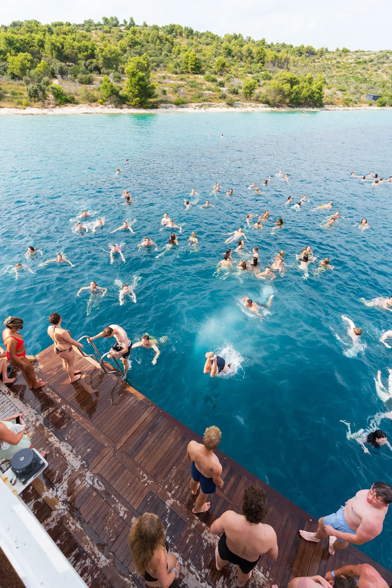 people jumping in the sea from the boat