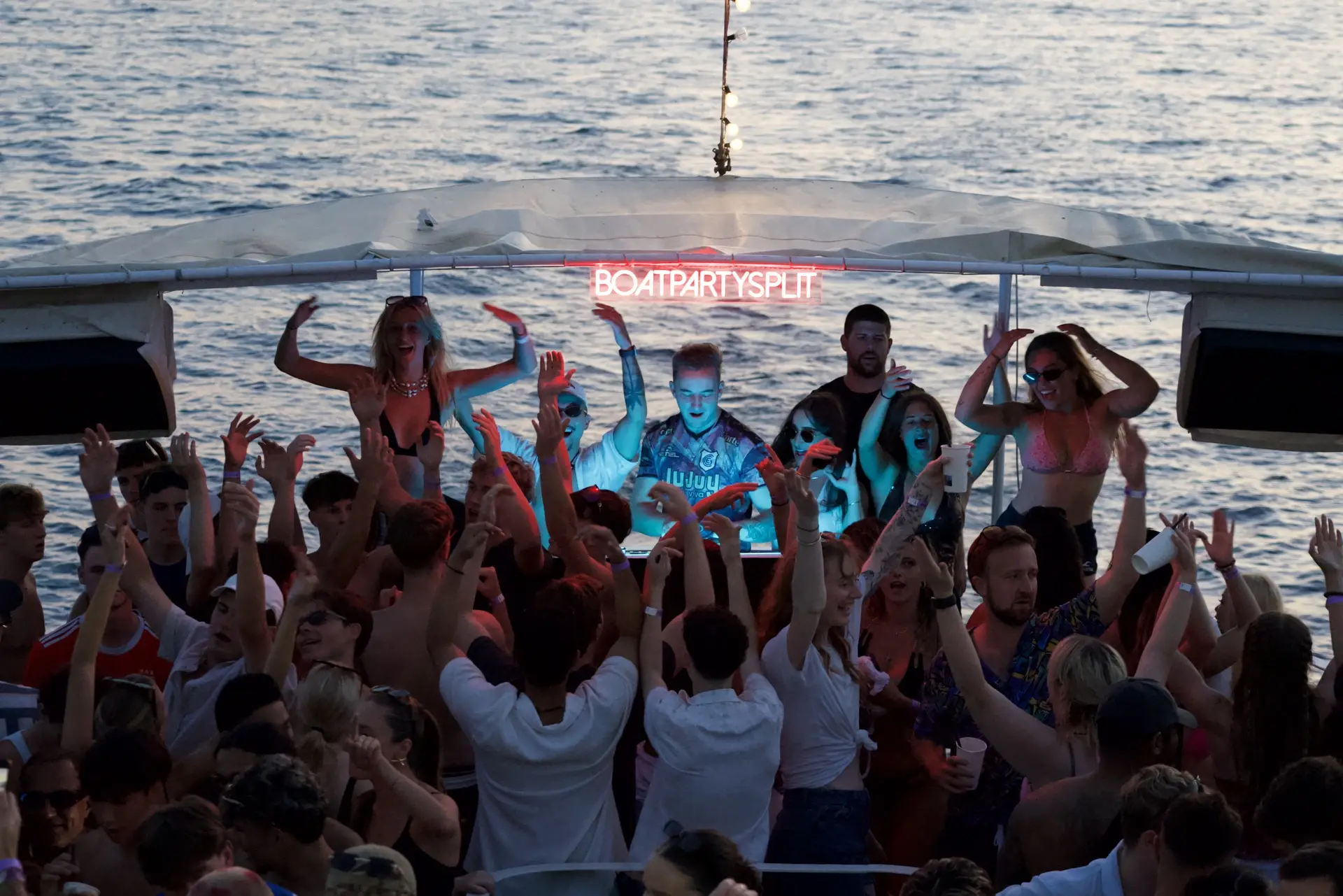 group of people in front of a dj at the boat