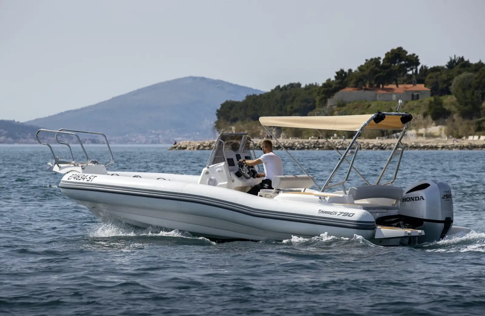 man driving fast boat on a sea