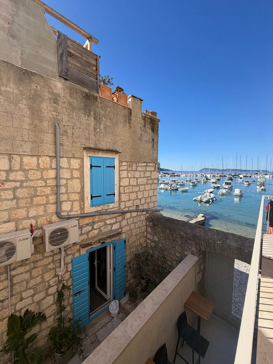 old stone house with seaview backdrop and boats
